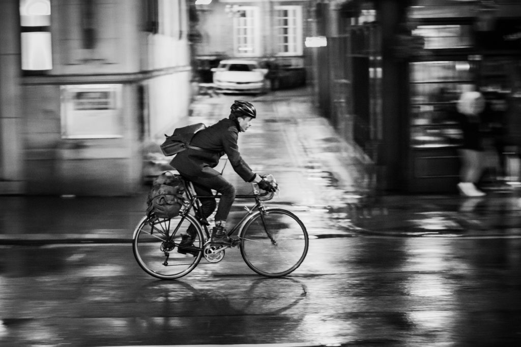 A cyclist hurrying home after a day of work.